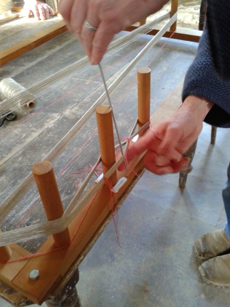 Warp-weighted Loom weaving - image of preparing the warp on a warp board