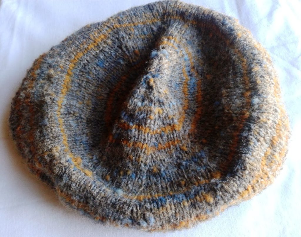 Image of handknit beret made from yarn spun from grey Ryeland wool including coloured carding waste