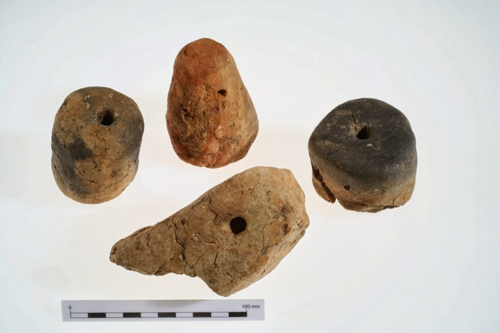 Warp-weighte Loom weaving - image of clay loom weights from an excavation at Huntsman's Quarry, Kemerton, Worcestershire. Photo by Neil Woolford