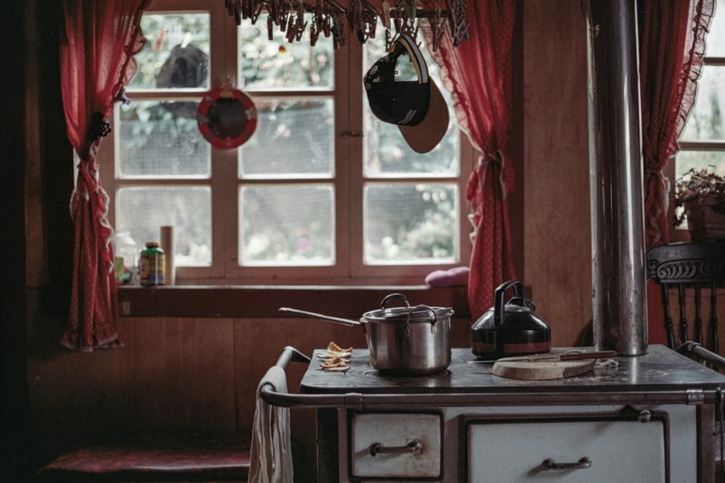 Imaginary homestead: image by Jens Johnsson looking across a stove, out of a kitchen window