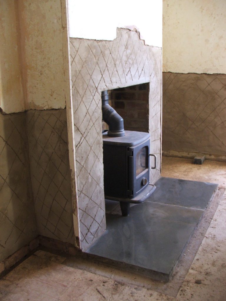 Zero waste house renovations: second-hand Morso Badger woodburner (ebay find), installed installed in partially complete fireplace