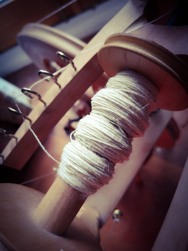 Zero Waste and climate change - image of nettle yarn on spinning wheel