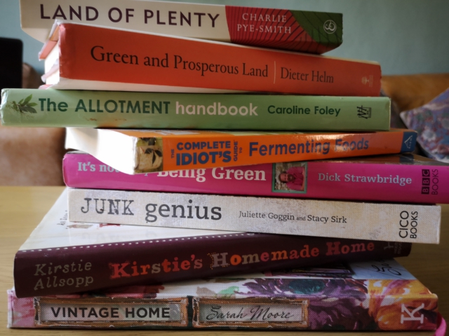 Zero waste knowledge is power - pile of books about repurposing junk, allotments, fermenting food and other green topics