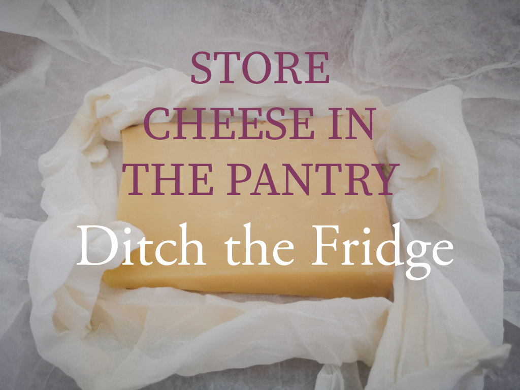 Store Cheese In The Pantry - Ditch the Fridge: Image of matured cheddar cheese in muslin and parchment paper, ready for storage