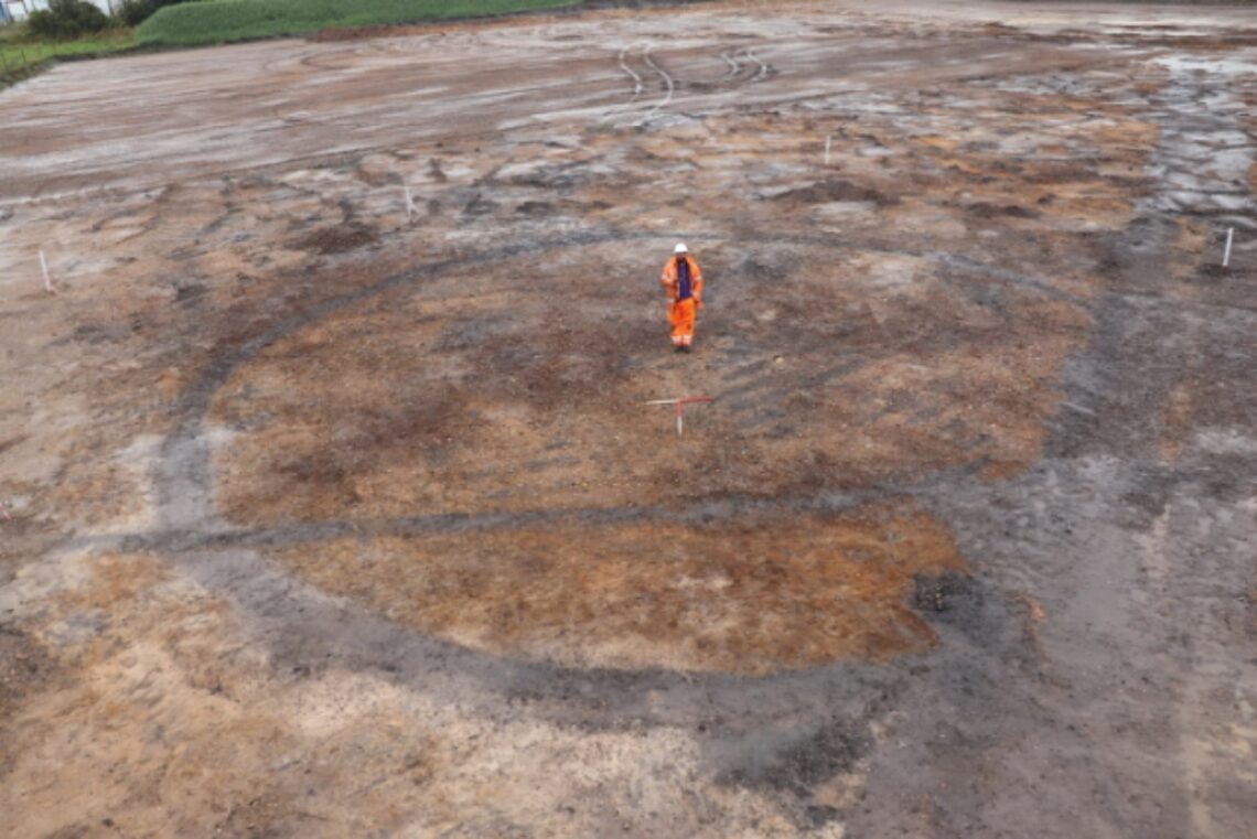 Soil stored area of a Staffordshire Quarry showing the exposed footprint of a prehistoric burial barrow: my husband standing in the centre of the exposed natural sands.