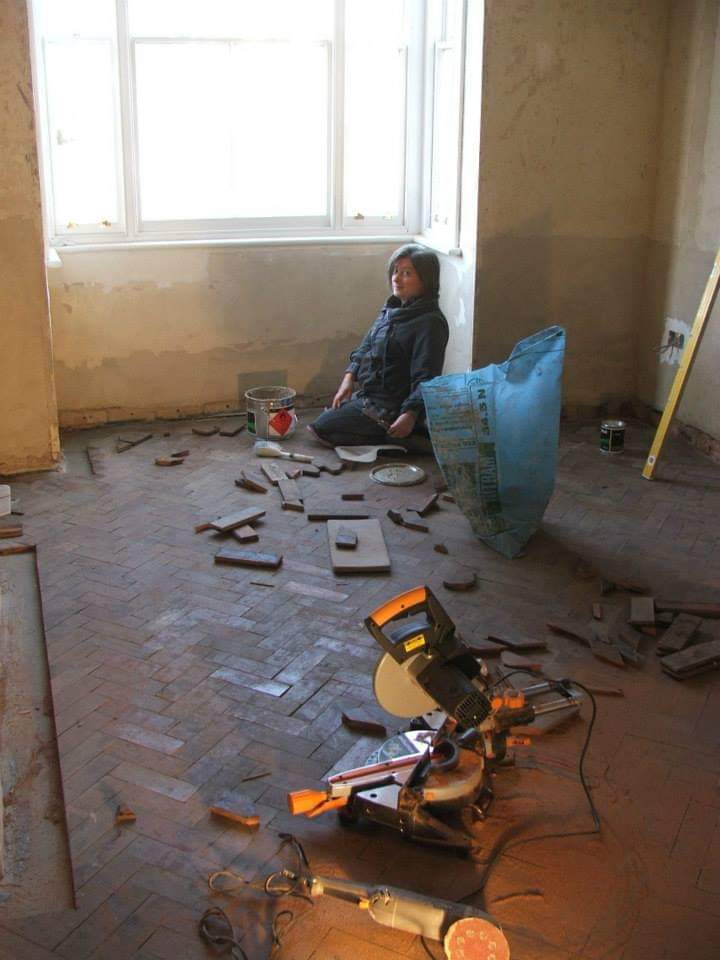 Laying salvaged parquet floor blocks in the front room