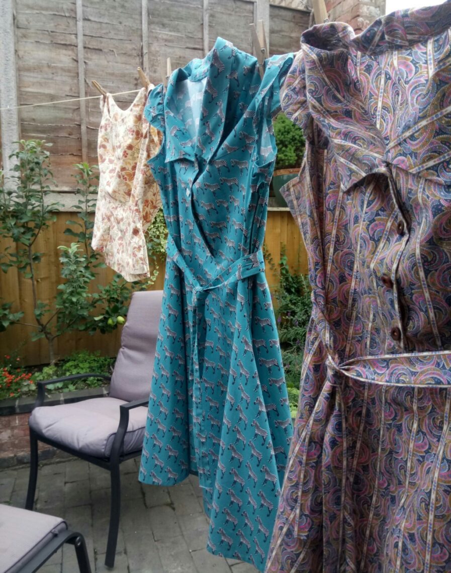 Sewing motivation hacks - home sewn dresses and a summer top, hanging on a washing line. All made from sewing patterns drafted from scratch.
