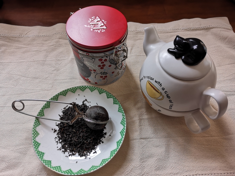 Unpackaged Food Revolution - image of a tea caddy, tea pot and loose lef tea, with a tea infuser