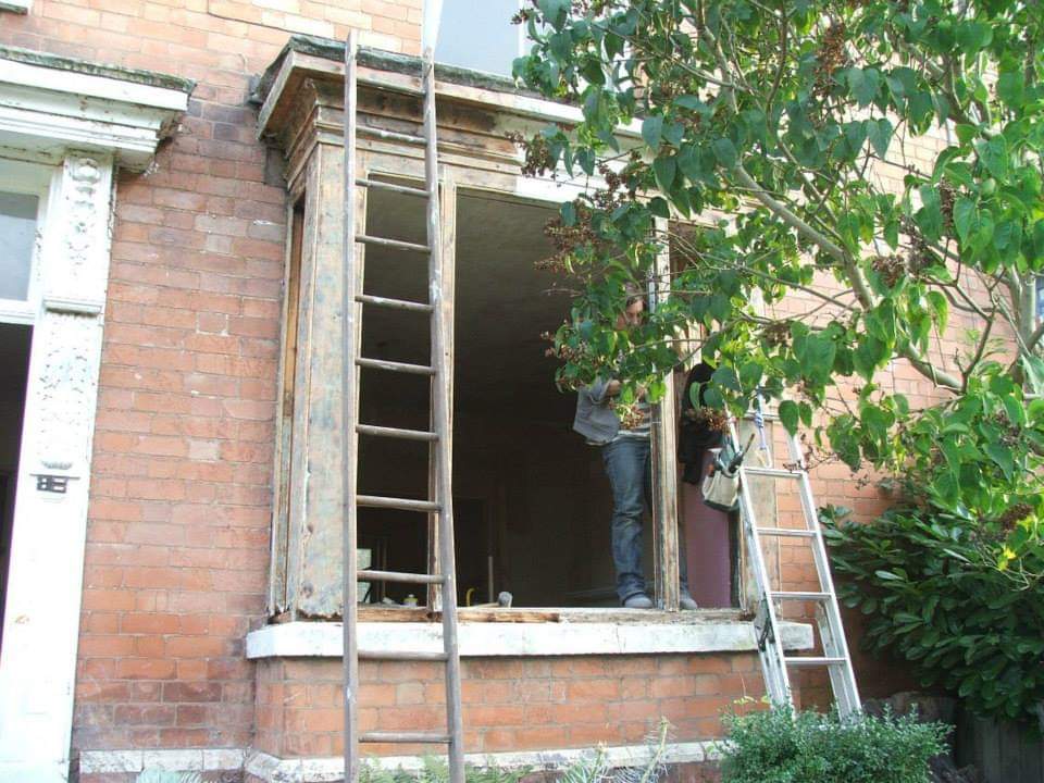 Dismantled box bay window, with internal sashes removed, and paint stripped from wood frame