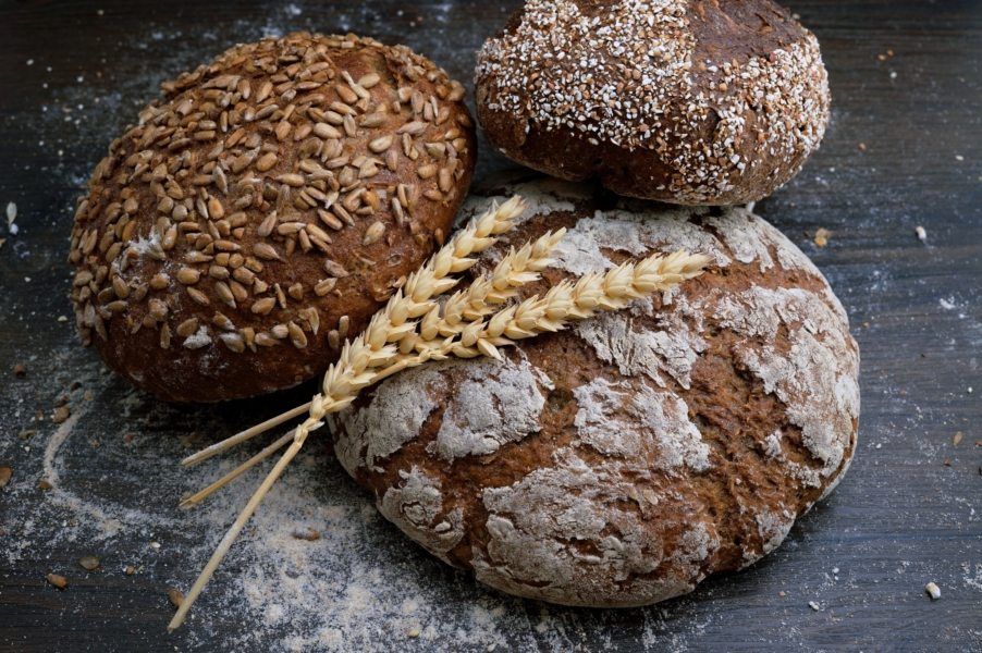 Diverse Grains and Pulses - image of three loaves of bread: brown and white, seeded and unseeded. Photo byPhoto by Wesual Click on Unsplash